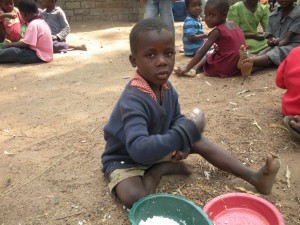 A boy in Mulanje, Malawi, receives food.