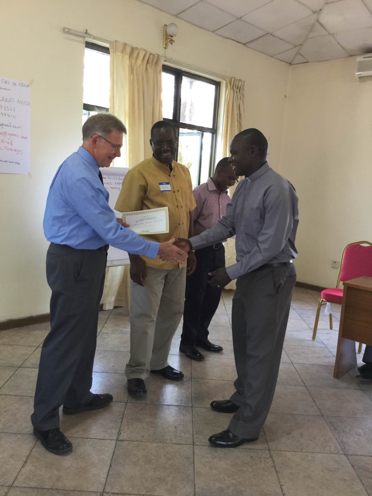 Wayne and Frank present a certificate to Rev. Domnic.