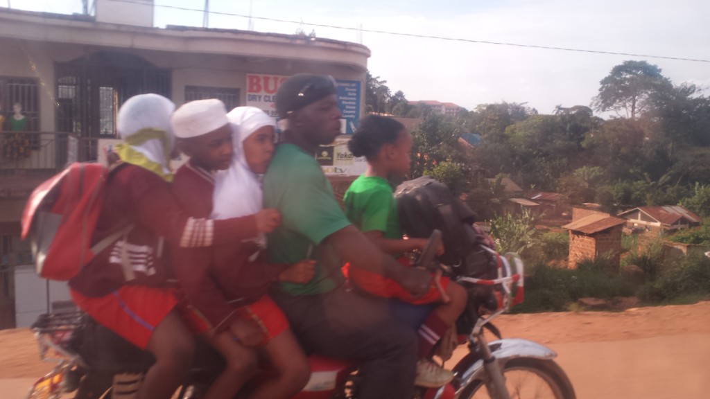 A family, or perhaps a carpool, on a boda-boda.