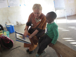 Linda reads with a child in Malawi.