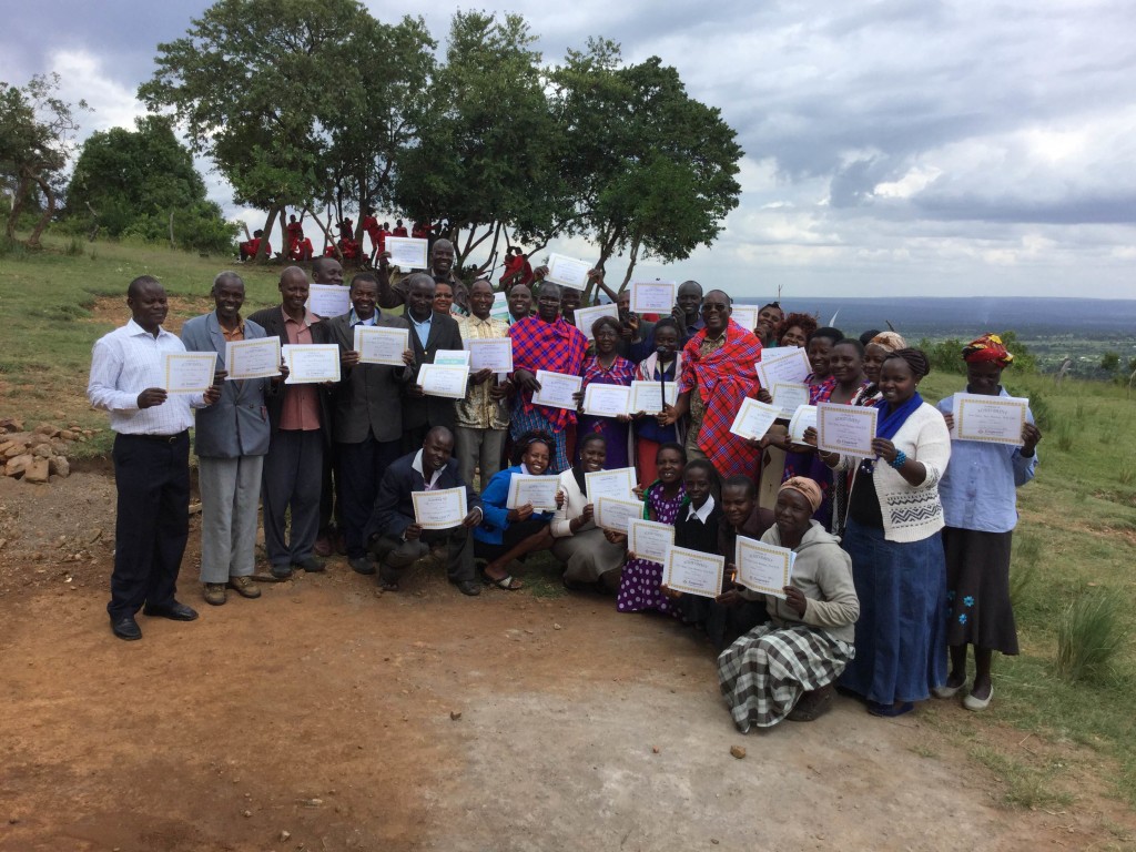 Proud graduates display their certificates.